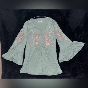 Cute bell sleeve top with boho embroidery along the bust and sleeves.